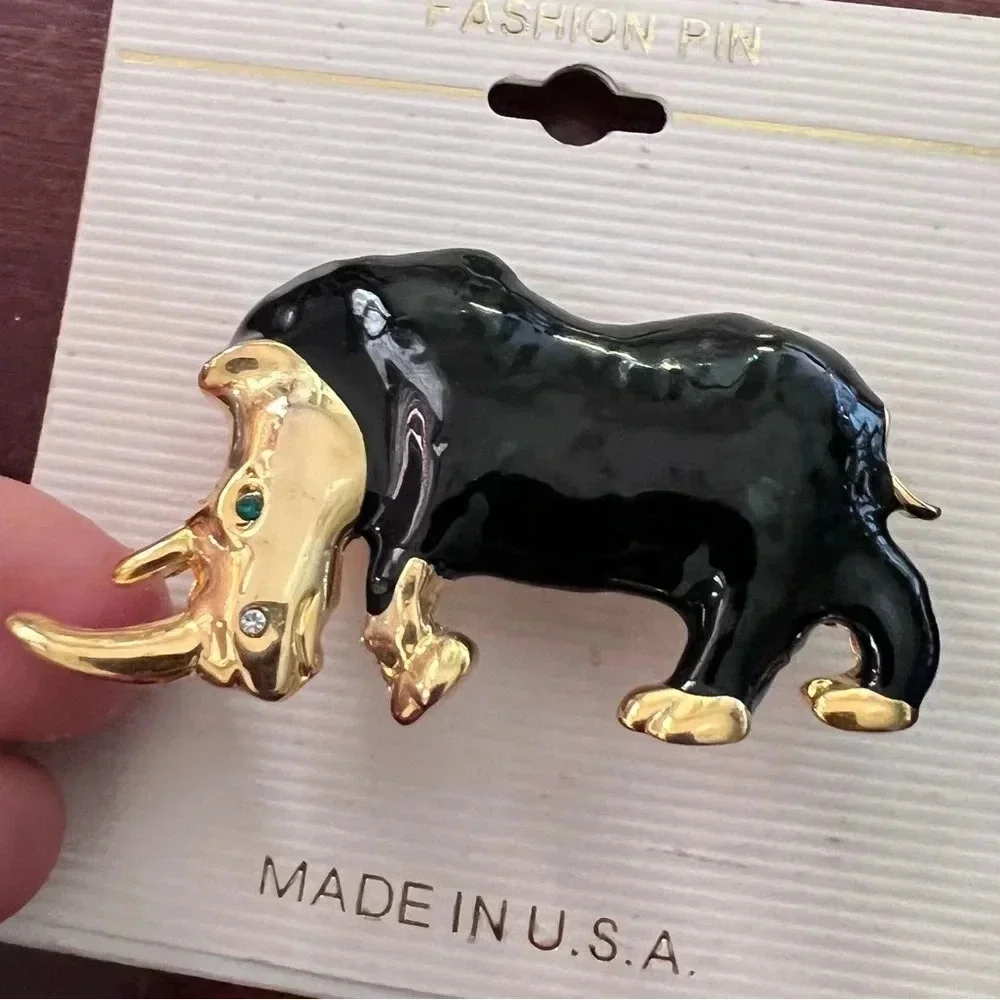 Vintage Black and Gold Rhinoceros Brooch with green sparkling eye
